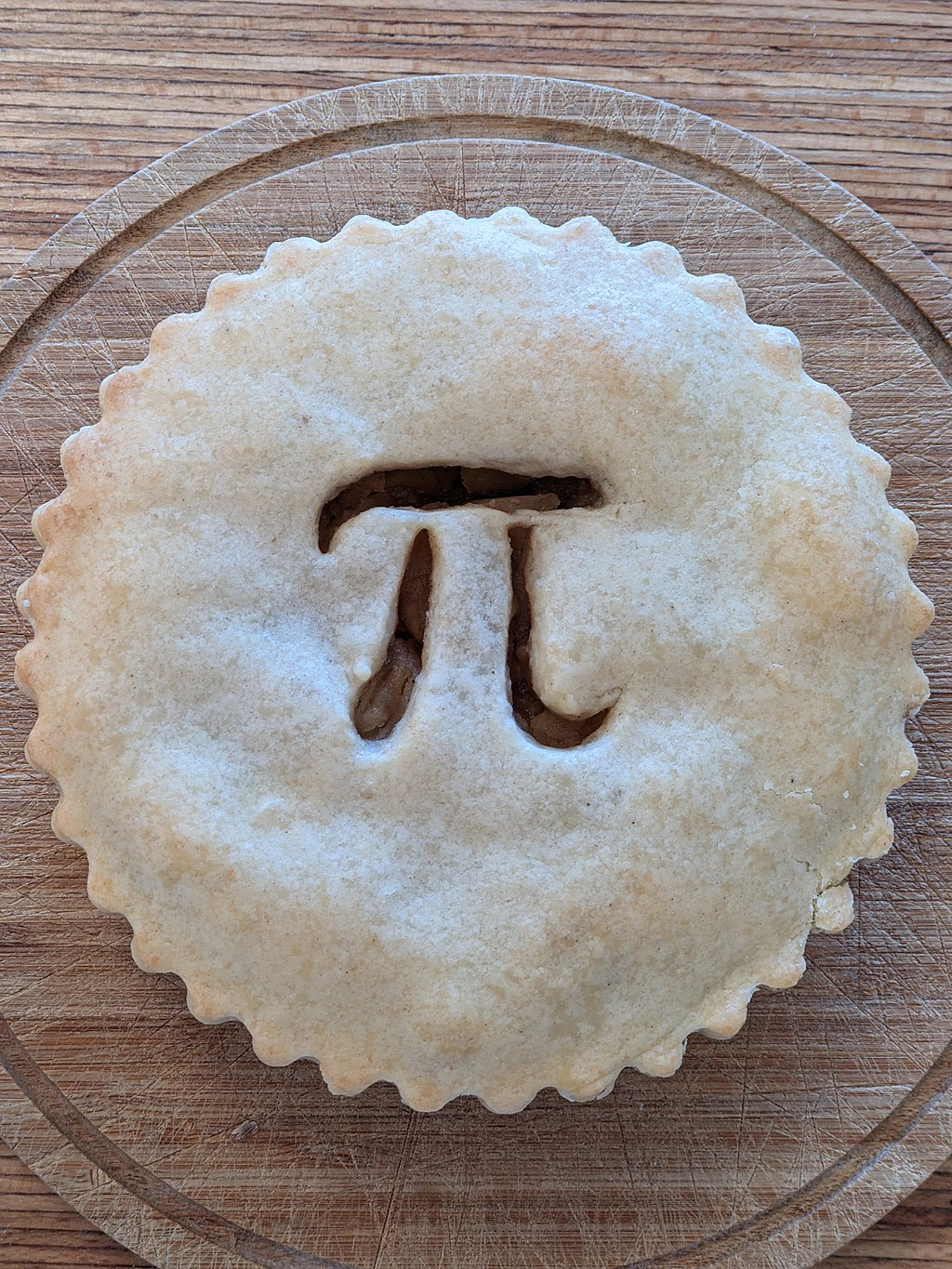 Pi pie. Source https://commons.wikimedia.org/wiki/File:Pie_day_apple_pie_5.jpg Shisma, CC BY 4.0 <https://creativecommons.org/licenses/by/4.0>, via Wikimedia Commons